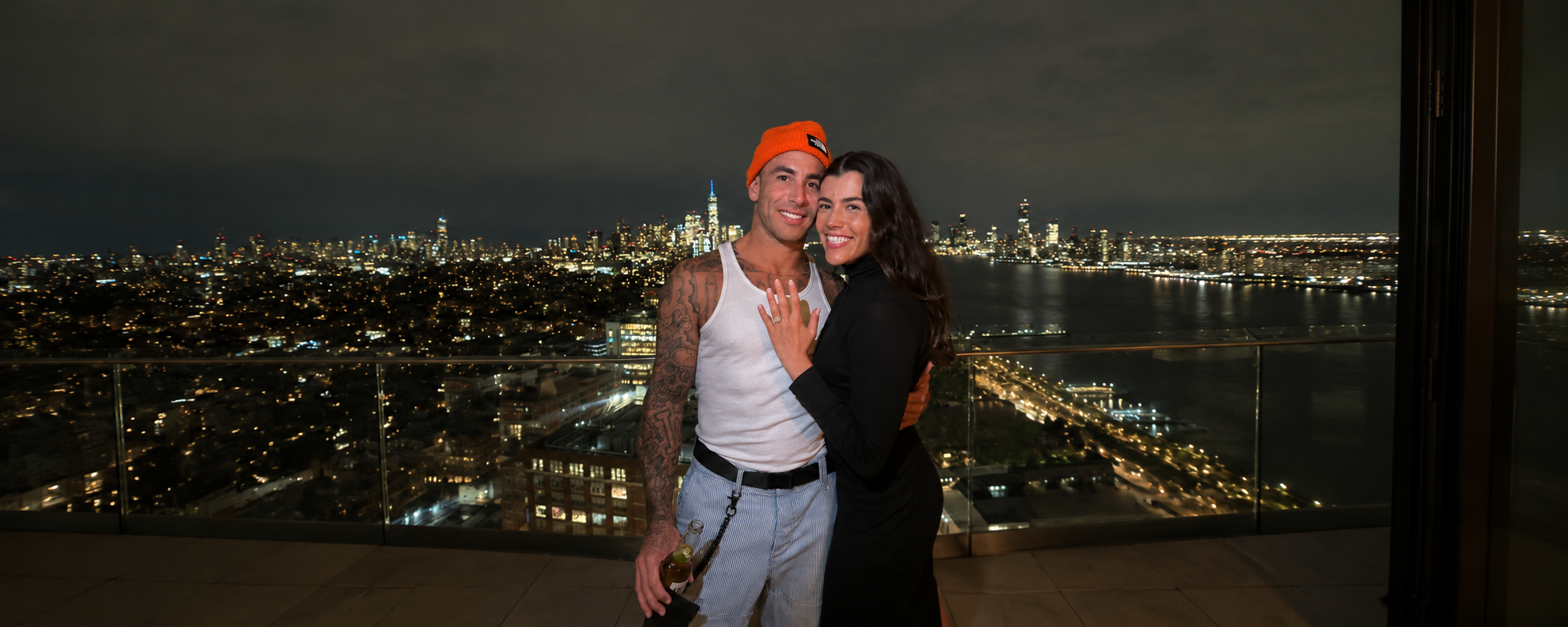Makena and Adam on a rooftop terrace after their engagement